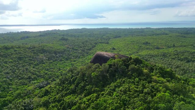 Belitung island drone aerial landscape Batu Beginda, a famous massive boulder overlooking the jungle, beach and ocean in Belitung, Indonesia