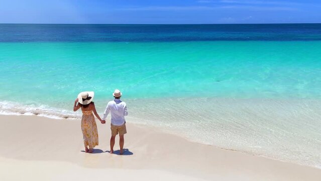 Aerial view of a holiday couple looking at the turquoise sea of the Caribbean island Antigua