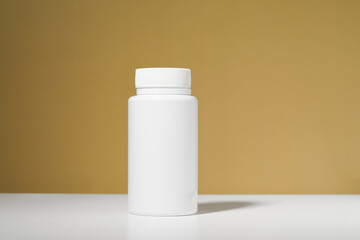 White mockup jar of pills on table on mustard background. Concept of pharmacy, medicine, tablets, capsules, antibiotics and health care