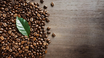 Dark Roasted Coffee Beans on Wooden and Burlap BackgroundDark Roasted Coffee Beans on Wooden and Burlap Background