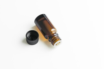 yellow glass bottle with essential aromatic oil on a white background