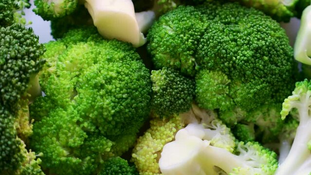 Fresh boiled green broccoli slices circle rotation close up top view