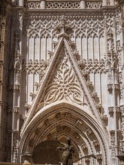 Seville cathedral gate and statues of saints. The Assumption Gate of the Cathedral of Seville (