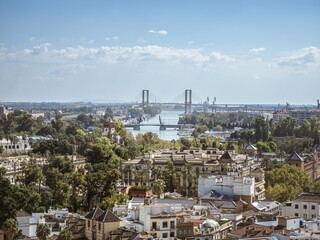 View of the town of Seville with the bridges of the city in the background as seen from the tower...