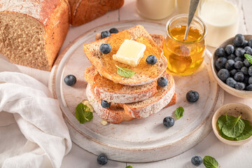 Tasty and sweet bread with berries, butter and maple syrup.