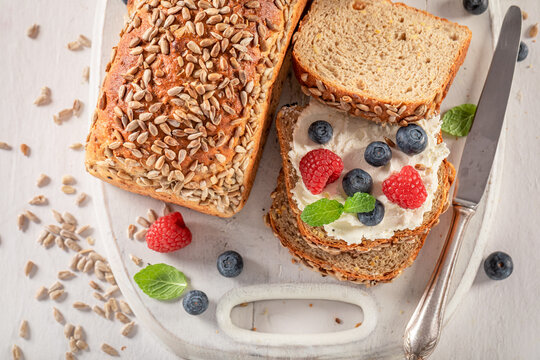 Healthy and sweet whole grain bread with cheese and berries.