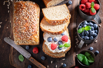 Healthy and homemade whole grain bread with cheese and berries.