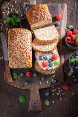 Healthy and homemade whole grain bread with cheese and fruit.