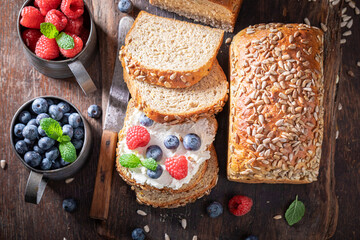 Healthy and homemade whole grain bread with raspberries and blueberries.