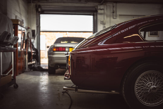 Fototapeta Classic cars being restored in a vintage vehicle garage workshop