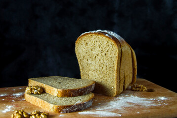 Fresh delicious buckwheat bread with walnuts on a wooden board.
