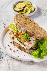sandwich on bread with ham, cucumber and cream cheese
