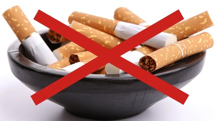 In a black bowl there are broken cigarettes crossed out with a red cross, symbolizing the decision to quit smoking. International No Tobacco Day