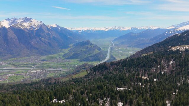 Panorama Grenze Schweiz zu Liechtenstein mit Ortschaft Balzers und Gebirge Regitzer Spitz und Ellhorn beim Rhein