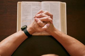Top view, praying and man with bible, hands and spiritual with religion and faith for guidance and...