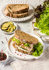 sandwich on bread with ham, cucumber and cream cheese