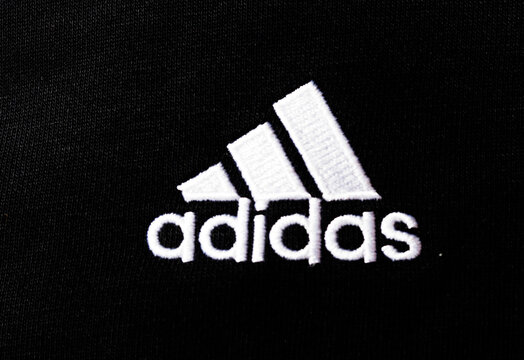 In this photo illustration,  Adidas AG logo seen displayed on a sportswear.