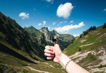 thumbs up of a hiker in mountains