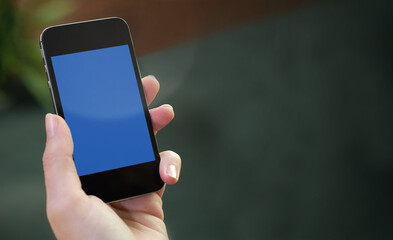 Hand holding tablet with blank screen