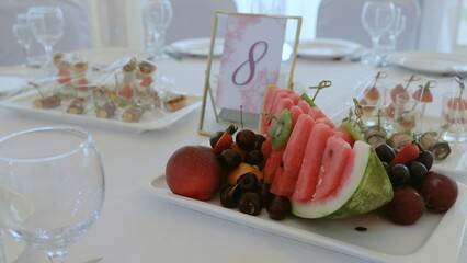 Elegant table setting in a luxurious restaurant. Luxurious banquet tables prepared for the official ceremony. A round table without food is served with plates, napkins, glasses and cutlery.