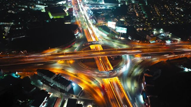 Time lapse of night city traffic on intersection roundabout in bangkok, thailand.
