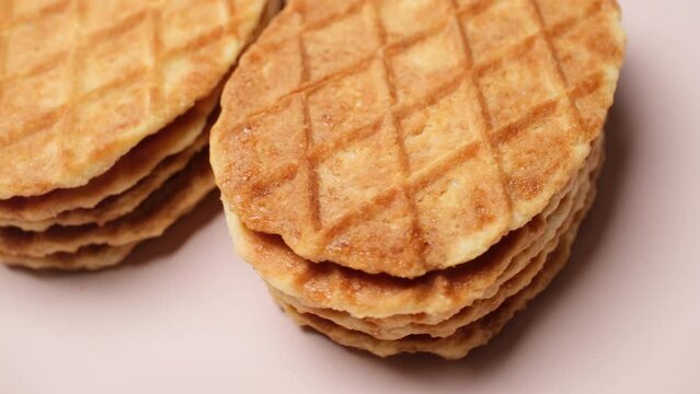 Close-up Belgium Crispy Butter Waffles pouring honey on 360 degree rotating plate