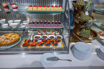 Close-up of the dessert display shelves in the hotel restaurant, showcasing a variety of sweet...
