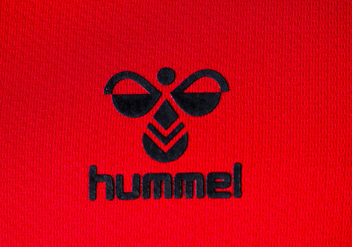 In this photo illustration,  Hummel International Sport & Leisure A/S logo seen displayed on a sportswear.