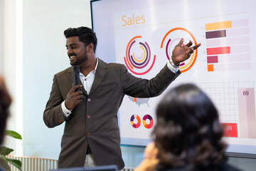 Presentation - Handsome indian business man people giving presentation and Report pointing at...