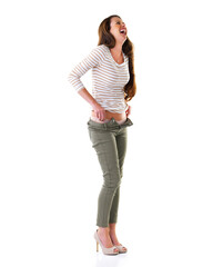 Fototapeta premium Woman, fashion and laugh in studio for casual, pants and cool clothes on white background. Female person, smile and jeans with humour, happiness and comedy on backdrop for apparel and mockup space
