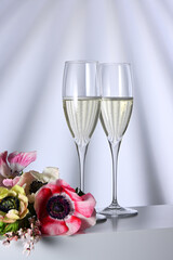 Two glasses with champagne and flowers - 790176763