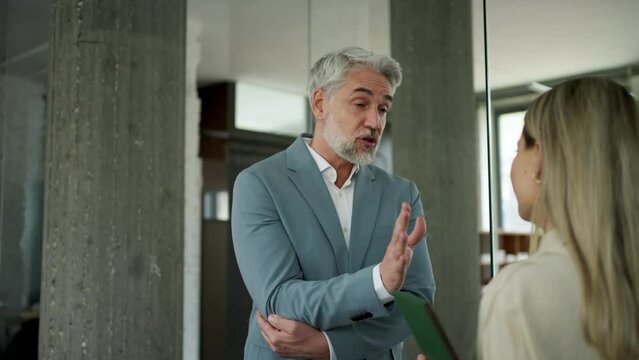 Manager scolding employee in modern office. Employee making mistake. Company director is angry, dissatisfied for worker's poor quality work and missed deadline.