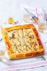 Puff pastry pie with cheese, pears, nuts and honey, served with champagne. - 790186583