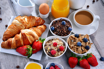Breakfast served with coffee, juice, croissants and fruits - obrazy, fototapety, plakaty