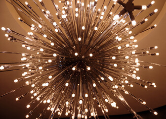 Illuminated modern chandelier seen from directly below