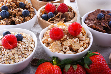 Bowls with different sorts of breakfast cereal products - 790193179
