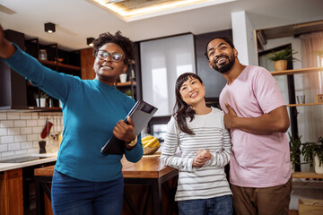 African American real estate agent showing house to multiracial couple, realtor telling clients about home advantages, interior designer discussing renovation ideas with homeowners. - 790198143