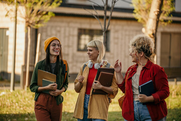 Female students enjoy a walk between classes, deep in conversation