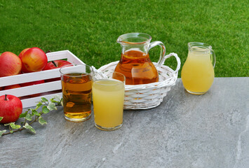 Crate with apples and apple juice on table with garden background.	 - obrazy, fototapety, plakaty