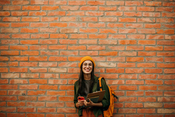 Ambitious young woman ready for academic challenges, portrayed against a campus brick wall with...