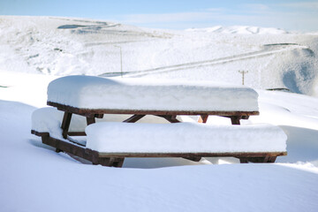 Picnic table in snow-covered landscape