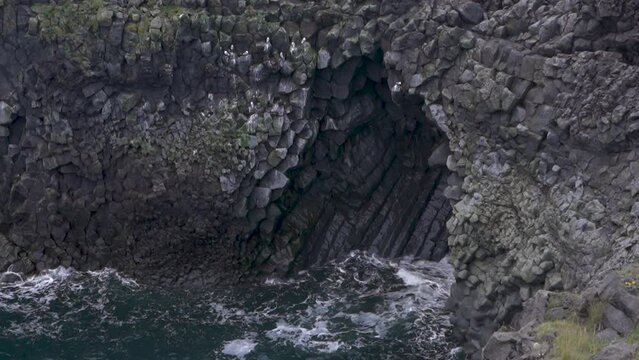 Basalt Cliff in Arnarstapi Iceland. Ocean Coast Waves Hit Rock.