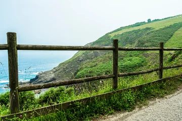 Photo sur Plexiglas Atlantic Ocean Road path with wooden fencing along the Atlantic Ocean, Northern Route Basque Country