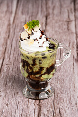 Green tea ice cream in glass cup.Collection of different desserts.Gourmet summer dessert of artisanal or craft ice cream made.Cafe menu.