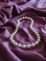  White pearl necklace on purple  satin