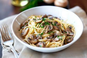 tasty spaghetti pasta with mushroom sauce in a white bowl