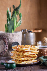 Belgian waffles served with honey, cream and sai on a wooden background. Rustic style. - 790233556
