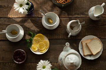 Porcelain tea set on wooden table.