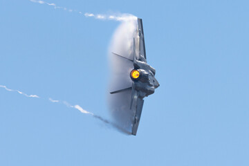 Very  close view of a F-35C Lightning II  in a high G turn, in a condensation cloud, with trails at...