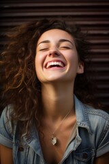 Close-up portrait of a girl against the wall, laughing with her head thrown back, happy. Generative AI.